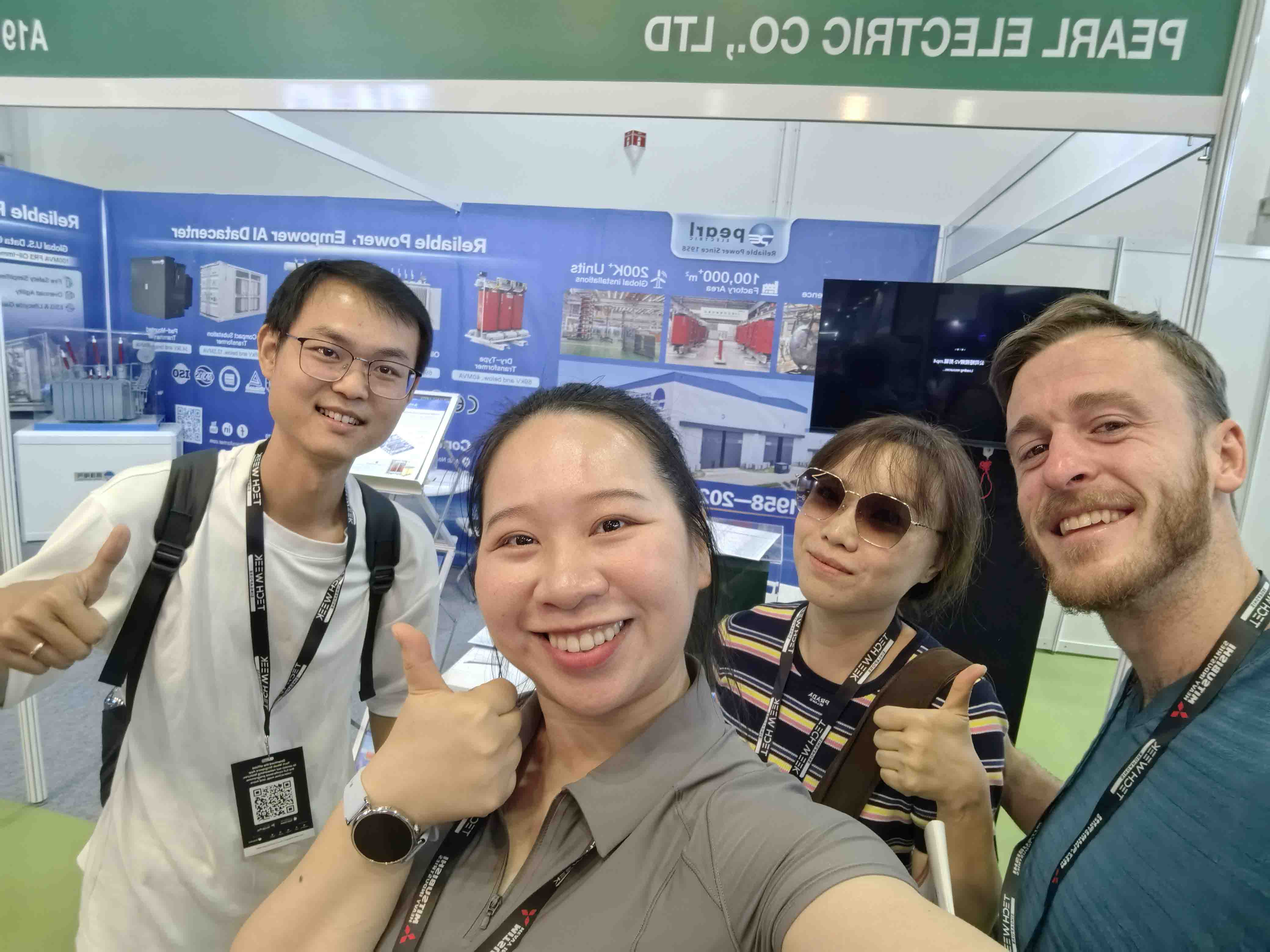 Pearl Electric sales engineers pose for a photo with a transformer client