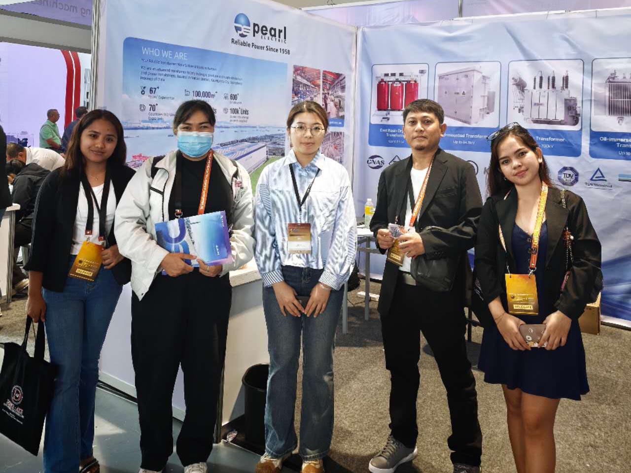 Pearl Electric transformer sales engineer poses for a photo with client from the Philippines